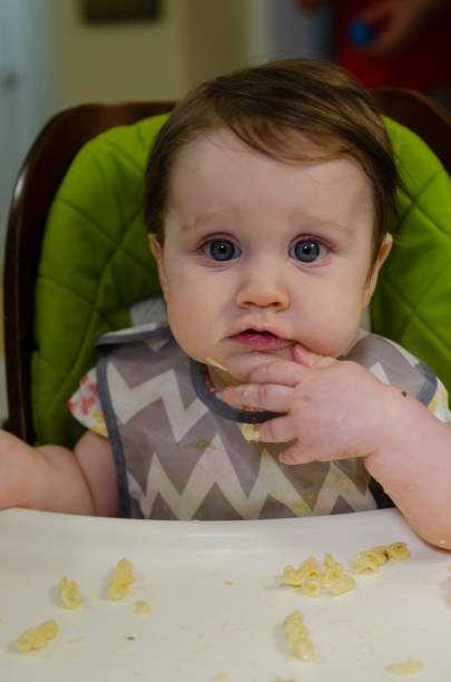 istock Baby Girl Eating 2174183603