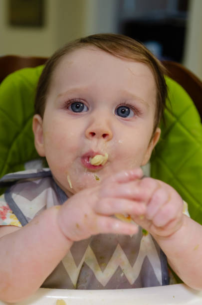 istock Baby Girl Eating 2174183615