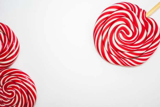 Handmade big lollipop on coral pink background