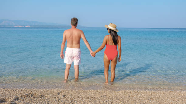 istock Couple enjoying a serene day at Brac Island's stunning beach under the warm sun 2174186921