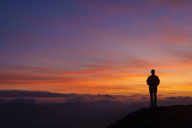 istock Man at sunset. Sky at sunset in San Miguel de Aralar, Navarra. 2174191504