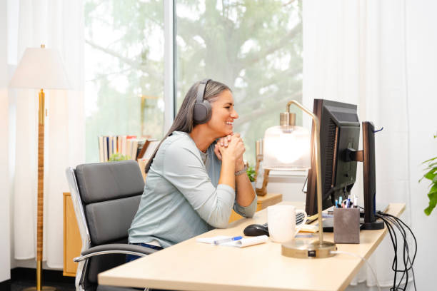 istock Mature female therapist smiles while talking with a client during a teleconference 2174191852