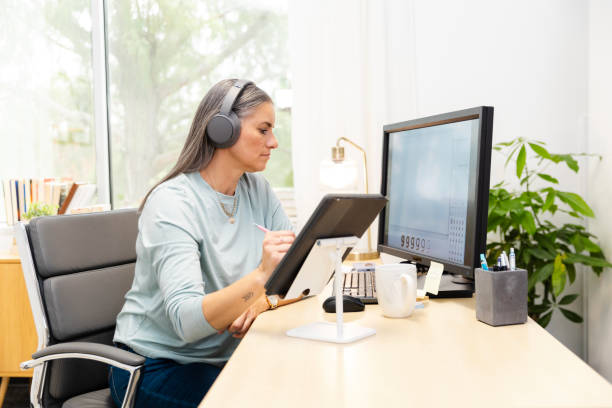 istock Businesswoman uses her digital tablet to take notes while working on a project for work 2174191899