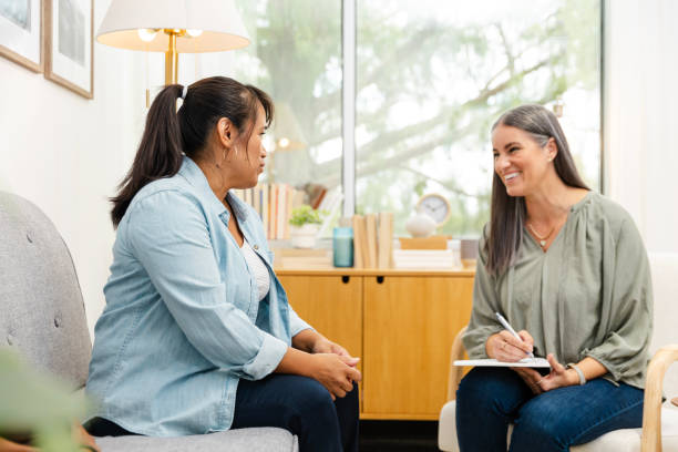 istock Mature female counselor smiles while meeting with her client in the office 2174191914