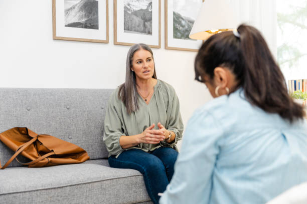 istock Over the shoulder view of therapist taking notes while listening to her client 2174191933