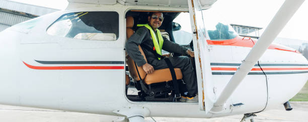 istock Pilot in uniform at airport. Asian Confident male pilot in uniform  and checking flight plan 2174193040