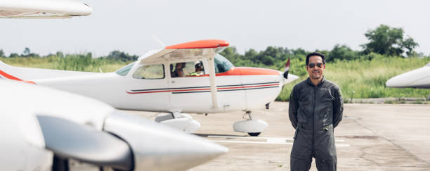istock Pilot in uniform at airport. Asian Confident male pilot in uniform  and checking flight plan 2174193065