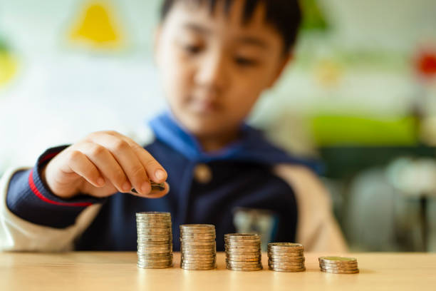 istock Asian boy is learning how to save money, which is the foundation for an important future life. 2174193331