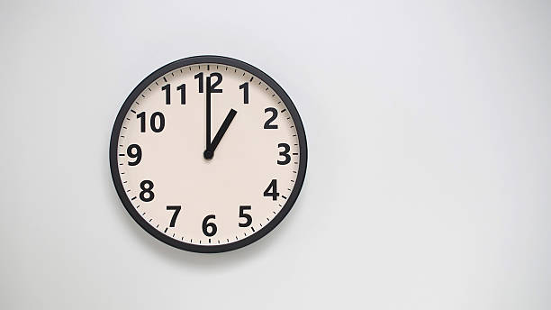 istock Classic Black-Edged Clock on White Background at 13.00/01.00 - Perfect for Time Management and Text Space 2174194239