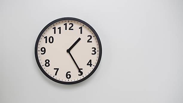 istock Classic Black-Edged Clock on White Background at 13.25/01.25 - Perfect for Time Management and Text Space 2174194269