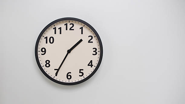 istock Classic Black-Edged Clock on White Background at 13.35/01.35 - Perfect for Time Management and Text Space 2174194278