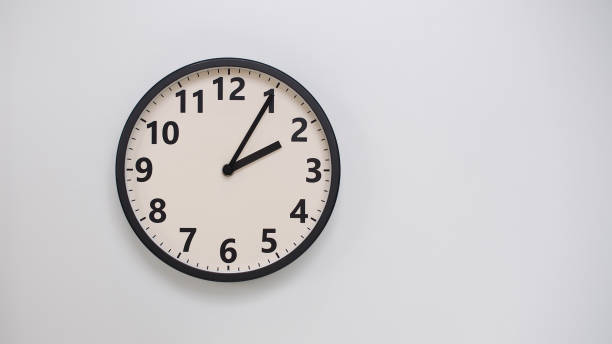 istock Classic Black-Edged Clock on White Background at 14.05/02.05 - Perfect for Time Management and Text Space 2174194909