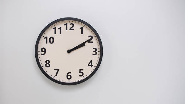 Classic Black-Edged Clock on White Background at 02.10 or 14.10 - Perfect for Time Management and Text Space