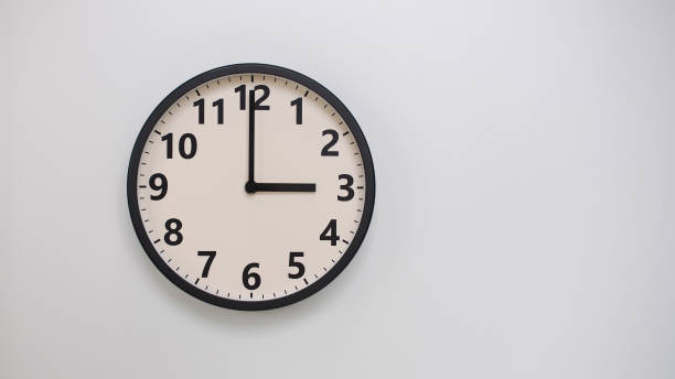istock Classic Black-Edged Clock on White Background at 15.00/03.00 - Perfect for Time Management and Text Space 2174195628
