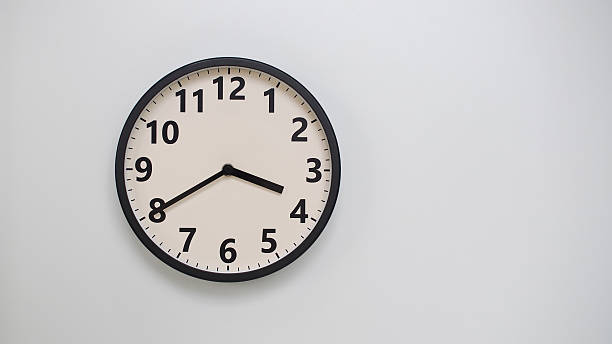 istock Classic Black-Edged Clock on White Background at 15.40 or 03.40 - Perfect for Time Management and Text Space 2174195643