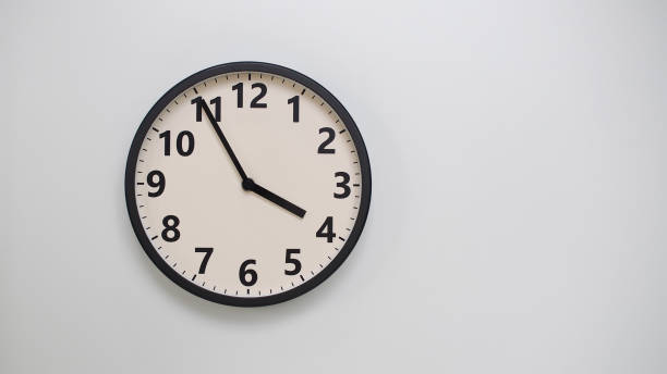 istock Classic Black-Edged Clock on White Background at 15.55 or 03.55 - Perfect for Time Management and Text Space 2174195665
