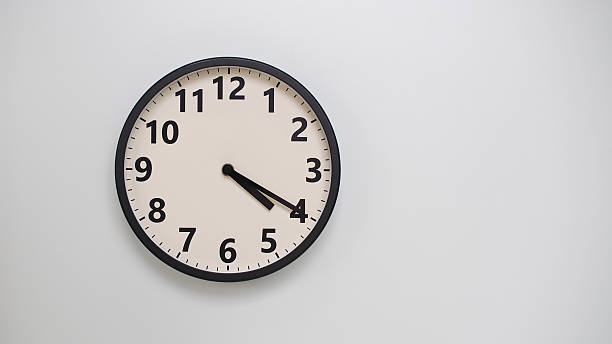 istock Classic Black-Edged Clock on White Background at 16.20 or 04.20 - Perfect for Time Management and Text Space 2174195668