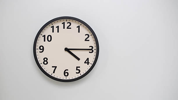 istock Classic Black-Edged Clock on White Background at 16.15 or 04.15 - Perfect for Time Management and Text Space 2174195680