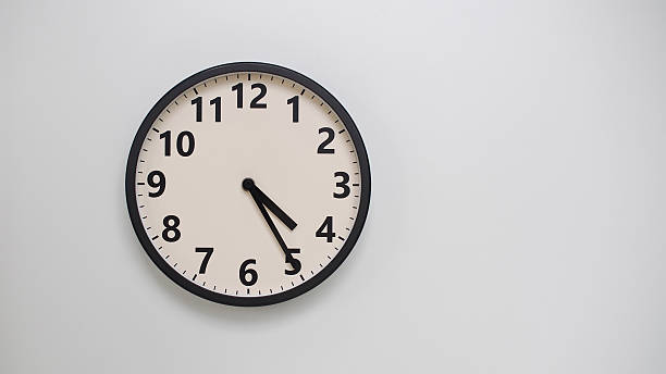 istock Classic Black-Edged Clock on White Background at 16.25 or 04.25 - Perfect for Time Management and Text Space 2174195691