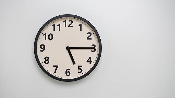 istock Classic Black-Edged Clock on White Background at 17.15 or 05.15 - Perfect for Time Management and Text Space 2174195740