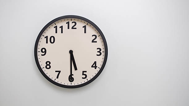 istock Classic Black-Edged Clock on White Background at 17.30 or 05.30 - Perfect for Time Management and Text Space 2174195781