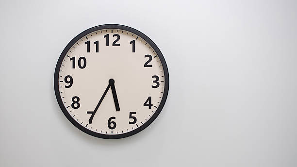 istock Classic Black-Edged Clock on White Background at 17.35 or 05.35 - Perfect for Time Management and Text Space 2174195796