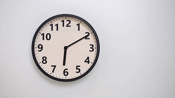 istock Classic Black-Edged Clock on White Background at 18.10 or 06.10 - Perfect for Time Management and Text Space 2174195815