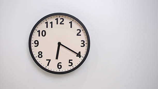 istock Classic Black-Edged Clock on White Background at 18.20 or 06.20 - Perfect for Time Management and Text Space 2174195838