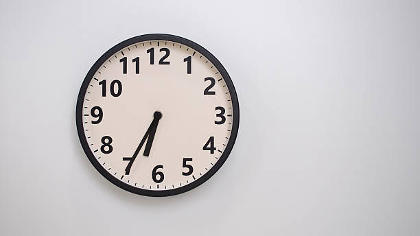 istock Classic Black-Edged Clock on White Background at 18.35 or 06.35 - Perfect for Time Management and Text Space 2174195855