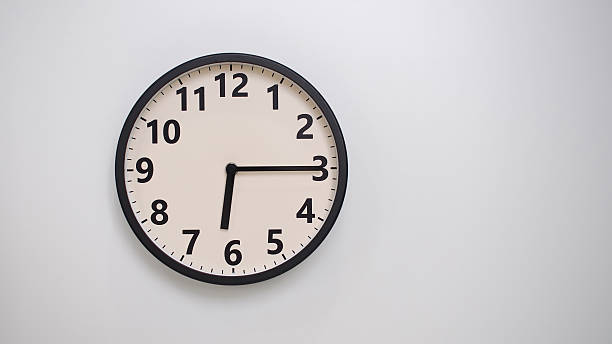 istock Classic Black-Edged Clock on White Background at 18.15 or 06.15 - Perfect for Time Management and Text Space 2174195867