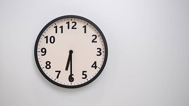 istock Classic Black-Edged Clock on White Background at 18.30 or 06.30 - Perfect for Time Management and Text Space 2174195901