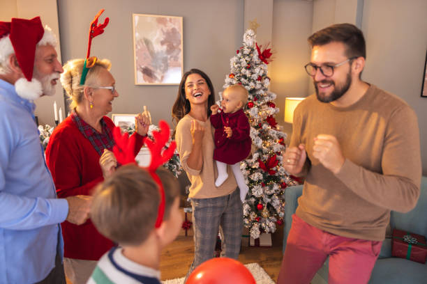 istock Multi-generation family having New Year party at home, singing and dancing 2174196049