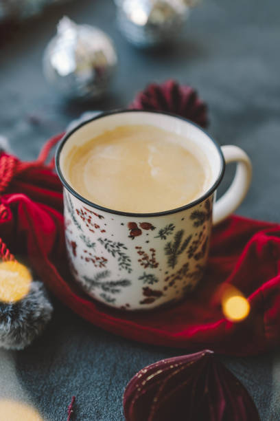 istock A warm beverage sits in a decorative mug next to a gift and holiday ornaments 2174197504