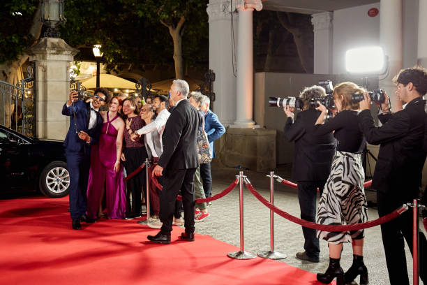 istock Celebrities taking selfie with fans at red carpet event 2174197668