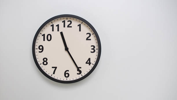 istock Classic Black-Edged Clock on White Background at 11.25 or 23.25 - Perfect for Time Management and Text Space 2174197751
