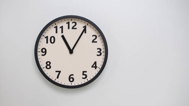 istock Classic Black-Edged Clock on White Background at  11.05 or 23.05 - Perfect for Time Management and Text Space 2174197754