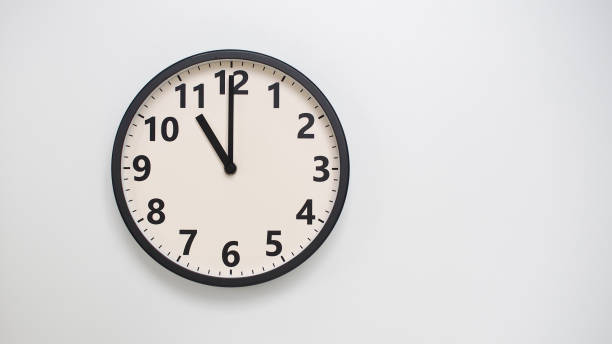 Classic Black-Edged Clock on White Background at 23.00 or 11.00 - Perfect for Time Management and Text Space