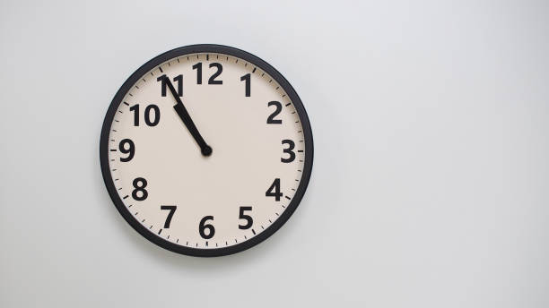 istock Classic Black-Edged Clock on White Background at 10.55 or 22.55 - Perfect for Time Management and Text Space 2174197758
