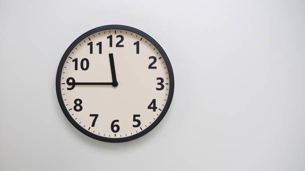 istock Classic Black-Edged Clock on White Background at 11.45 or 23.45 - Perfect for Time Management and Text Space 2174197769