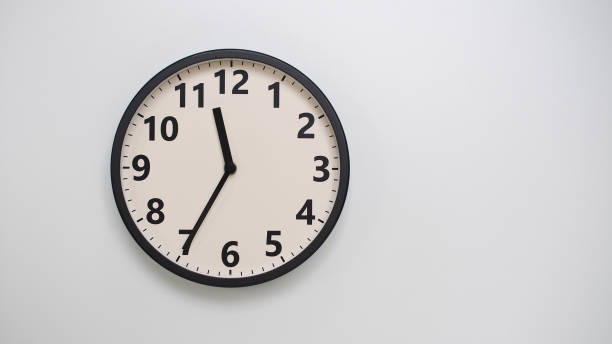 istock Classic Black-Edged Clock on White Background at 11.35 or 23.35 - Perfect for Time Management and Text Space 2174197771