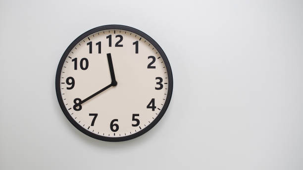 istock Classic Black-Edged Clock on White Background at 11.40 or 23.40 - Perfect for Time Management and Text Space 2174197773