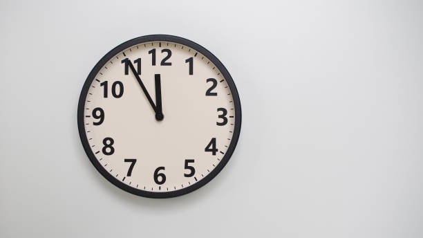 istock Classic Black-Edged Clock on White Background at 11.55 or 23.55 - Perfect for Time Management and Text Space 2174197774