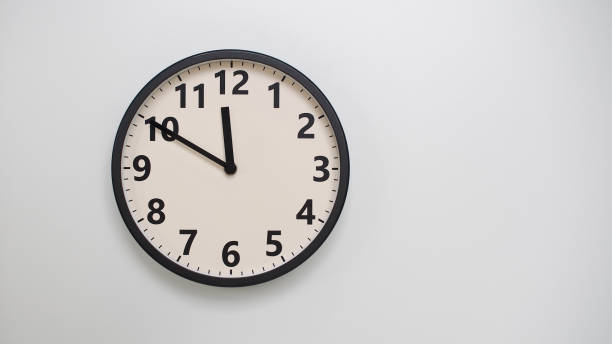 istock Classic Black-Edged Clock on White Background at 11.50 or 23.50 - Perfect for Time Management and Text Space 2174197777