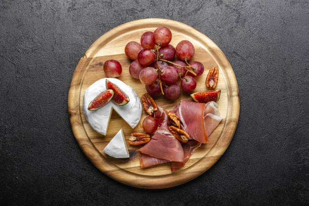 istock Appetizer board with meat, cheese, grapes, nuts and fresh figs. 2174198164