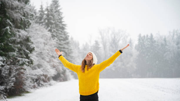 istock Woman practicing mindfulness standing in the middle of snowy nature 2174202239