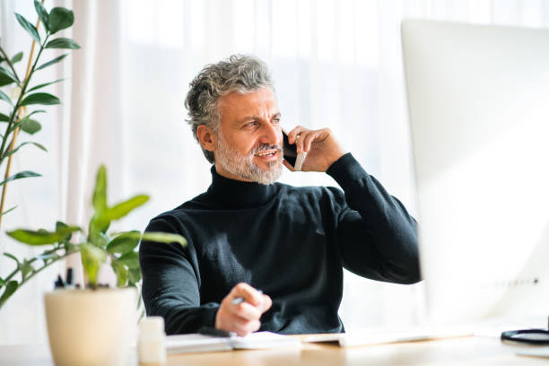 istock Homeoffice for handsome man. Man working in his office in home, making phone call. Telecommuting. 2174215117