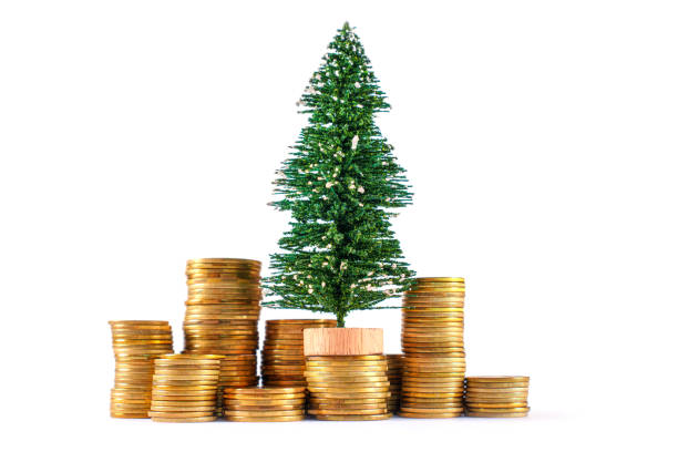 istock Christmas Tree Surrounded By Stacks Of Golden Coins Symbolizing Wealth 2174216416