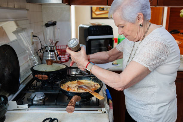 istock Senior woman cooking at home 2174220205