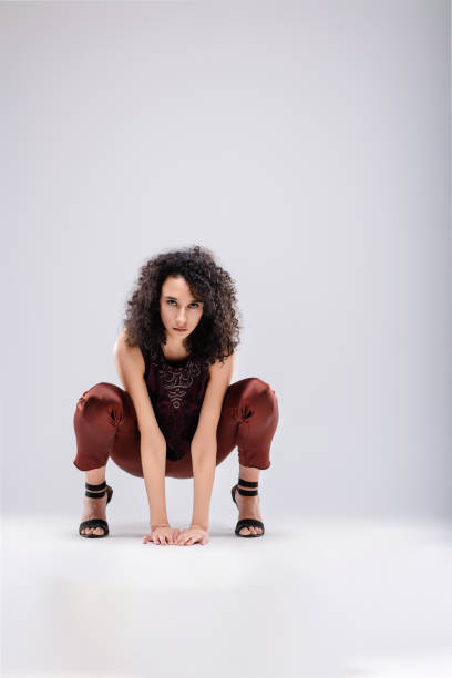 istock Fashion model crouching and posing on white background 2174220930