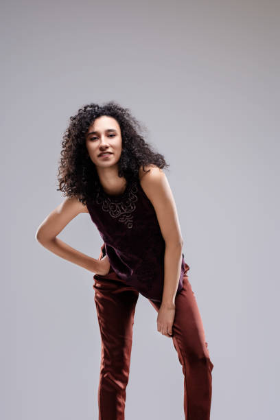 istock Fashion model posing with hand on hip and knee 2174221405